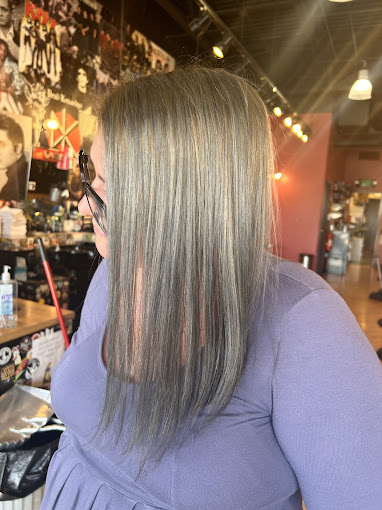 A woman with long hair and glasses in a store