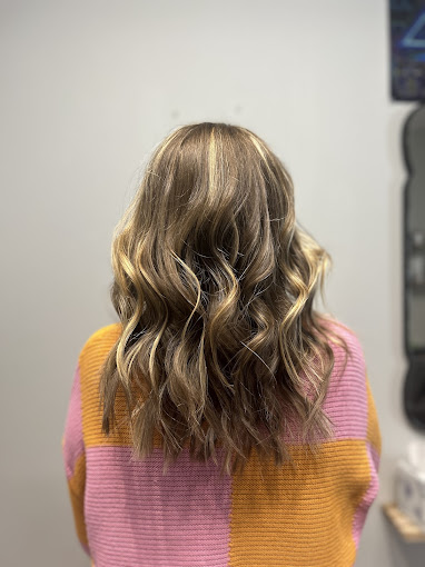 The back of a woman's head with wavy hair