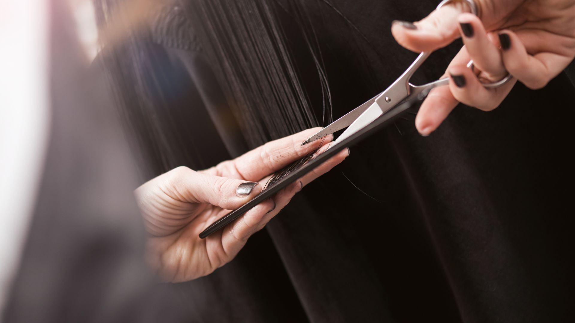 A woman holding a pair of scissors in her hands